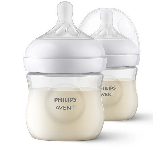 Pack 2 mamaderas Natural Response 125ml anticólicos - Avent con leche sobre fondo blanco